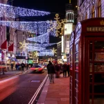 A London phonebox With Christmas lights strung across the street