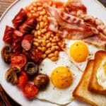 A full English breakfast on a white plate