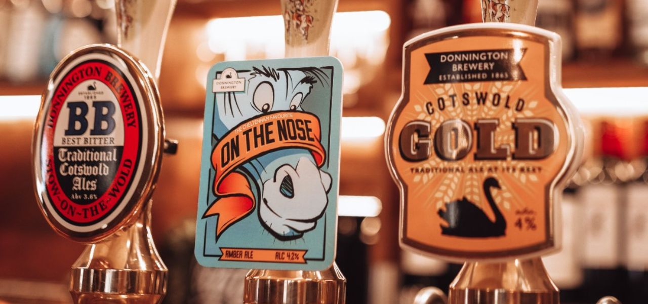 Pump badges on Cotswold pub beer pumps